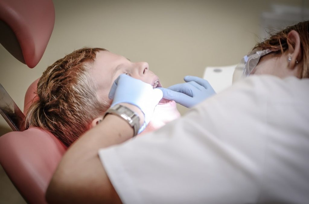 family dentist checking little patient in NW Calgary