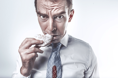 Man eating food that can harm his teeth